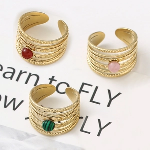 French palace style gold rings set with natural red, pink, and green stones and texture