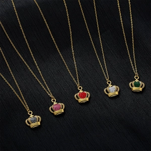 Macro detail of crown pendants with colorful zircon stones on gold necklaces