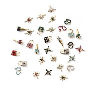 Assorted gold-plated snake and star pendants with colorful rhinestones on white base