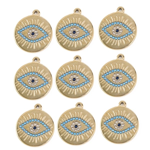 Detail of bohemian evil eye charms with colorful crystals and gold sunburst texture
