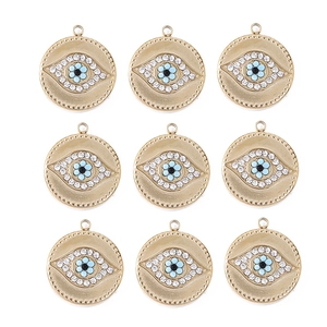 Macro view of nine gold stainless steel evil eye charms with blue crystals and white rhinestones