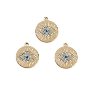 Detailed view of bohemian gold plated evil eye charms with blue and white crystals
