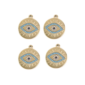 Set of four gold bohemian evil eye pendants with blue crystal details for DIY jewelry