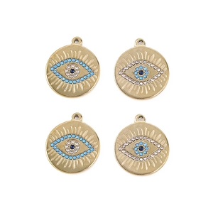 Detailed view of four golden evil eye pendants with blue beads and crystals for DIY jewelry