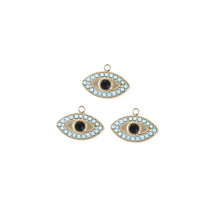 Detailed view of three gold evil eye pendants with blue beads and black center stones