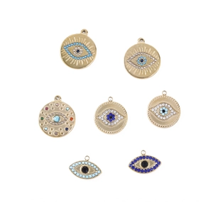 Close-up of seven bohemian evil eye charms in gold finish with colorful rhinestones