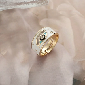 Adjustable gold evil eye ring with white enamel and sparkling zircon details