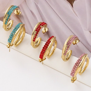 Three-pair set of gold C-shaped earrings with colorful crystals in blue, red, and pink stones