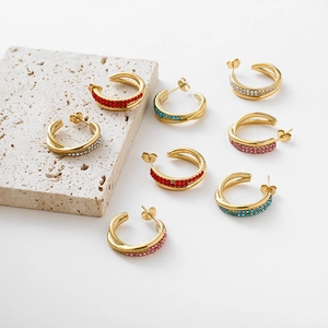 Gold C-shaped stainless steel earrings with colorful rhinestones in a cross design
