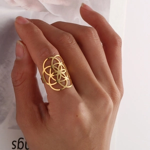 Detail of 18K gold plated stainless steel hollow flower ring with geometric patterns