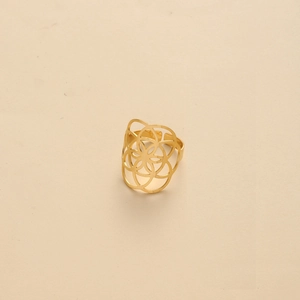Detailed view of wide open ring with geometric gold flower and seed of life motif