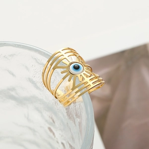 Golden hollow evil eye open ring featuring a blue eye bead in a radiant sunburst design