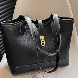 Large black pebbled leather tote bag with white contrast stitching and gold twist lock