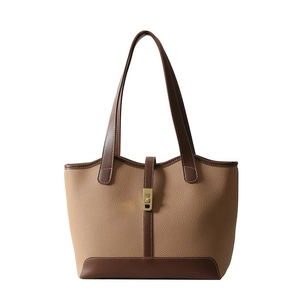 Two-tone leather tote bag in camel and brown with a gold metal clasp for office use