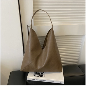 Minimalist brown faux leather tote bag with soft texture and unique triangular design