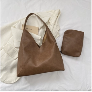 Detail of brown matte leather tote bag with unique diagonal stitching and matching pouch