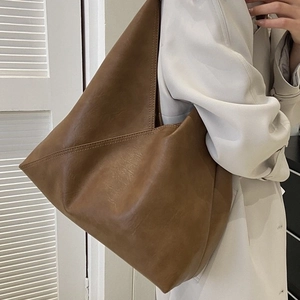 Brown soft leather tote bag featuring a geometric triangle fold design for a retro look