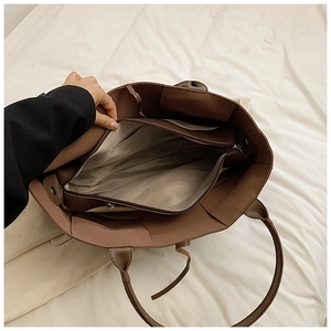 Top view of spacious brown woven tote bag interior with secure zipper pocket