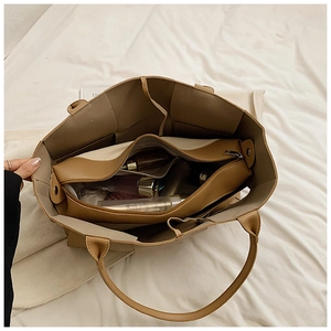 Top view of spacious khaki woven tote interior with a removable zippered inner pouch