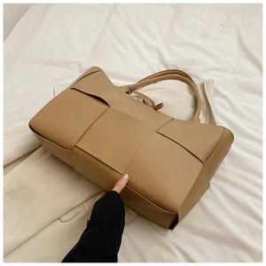 Top view of khaki woven tote bag showing premium leather texture and large capacity detail
