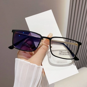 Detail of photochromic and blue light blocking lenses on black and gold square sunglasses