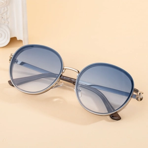 Fashionable round punk sunglasses for women with gold frame and blue gradient lenses