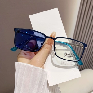 Detail of blue square frame glasses showing photochromic and blue light blocking lenses