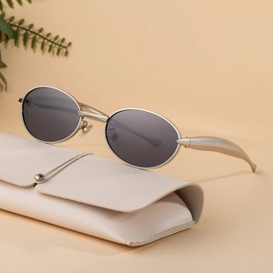 Minimalist oval sunglasses with silver metal frame and matching leather pouch case