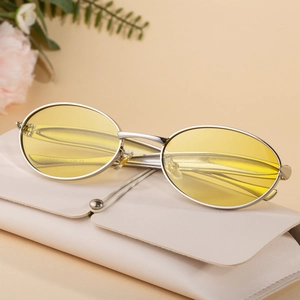 Retro oval sunglasses with silver metal frames, yellow lenses and pink leather case