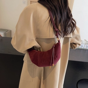 Burgundy matte suede crescent croissant bag worn with khaki coat for women