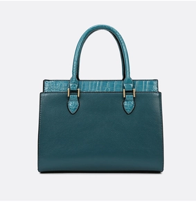 Detailed macro view of dark green tote with lychee and crocodile grain textures