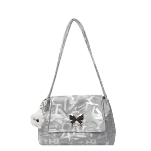 Silver tote bag with butterfly buckle, LOVE print, and plush monster charm on white background