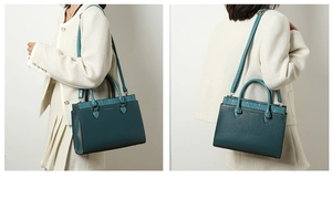 Detail of teal tote bag with crocodile pattern trim and adjustable shoulder strap