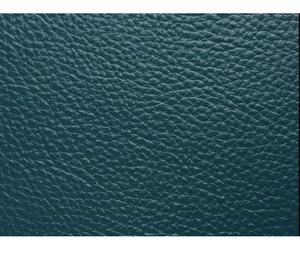 Close-up of dark green litchi texture leather material showing fine grain and quality