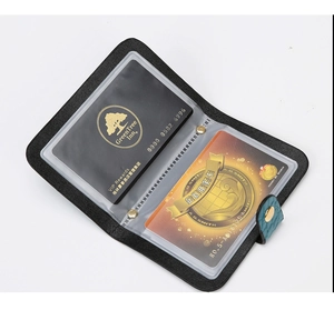 Detail view of black PU leather multi-card wallet with teal buckle and transparent PVC slots