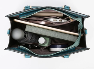 Internal view of dark green croc-embossed tote bag showing spacious compartments and liners