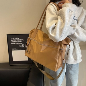 Caramel nylon tote bag with leather handles and multiple zipper compartments
