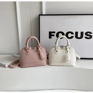 Detail of pink and beige shell bags featuring faux crocodile embossed leather texture