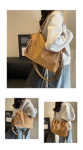 Detail view of khaki nylon tote bag showing durable water-resistant fabric and zippers