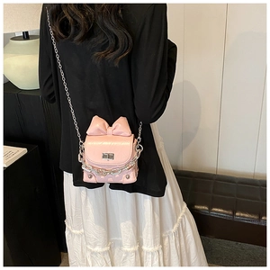 Model view of pink bow chain bag with glossy PU leather and silver metal crossbody strap