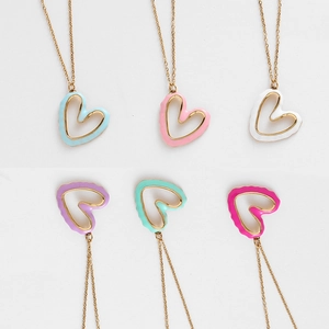 Detail view of heart-shaped hollow pendants in six colors with gold chains