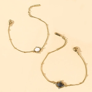 Detail of gold titanium steel bracelets with natural stones and lobster clasp closure