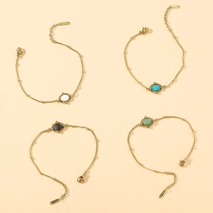 Detail of four gold-plated stainless steel bracelets with assorted oval natural gemstones