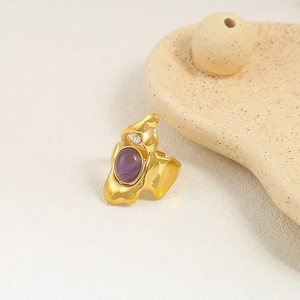 Irregular gold stainless steel ring with oval purple stone and accent white crystal