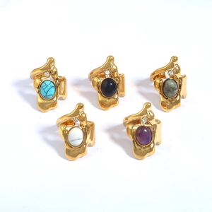 Detail of five gold-plated irregular lava rings with various inlaid natural stones