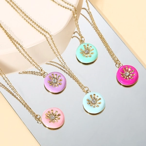 Detail of five colorful sunflower pendant necklaces with gold plating and rhinestones