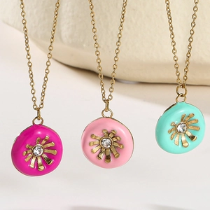 Detail of colorful enamel sunflower pendants with crystal centers on gold chains