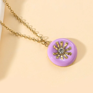 Close-up of circular purple enamel sunflower pendant with a sparkling center zircon