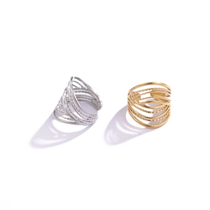 Detail of minimalist 18K gold and silver wide multi-layer textured ring set