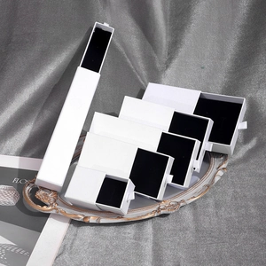 White sliding drawer jewelry boxes with black velvet liners in multiple sizes for sets